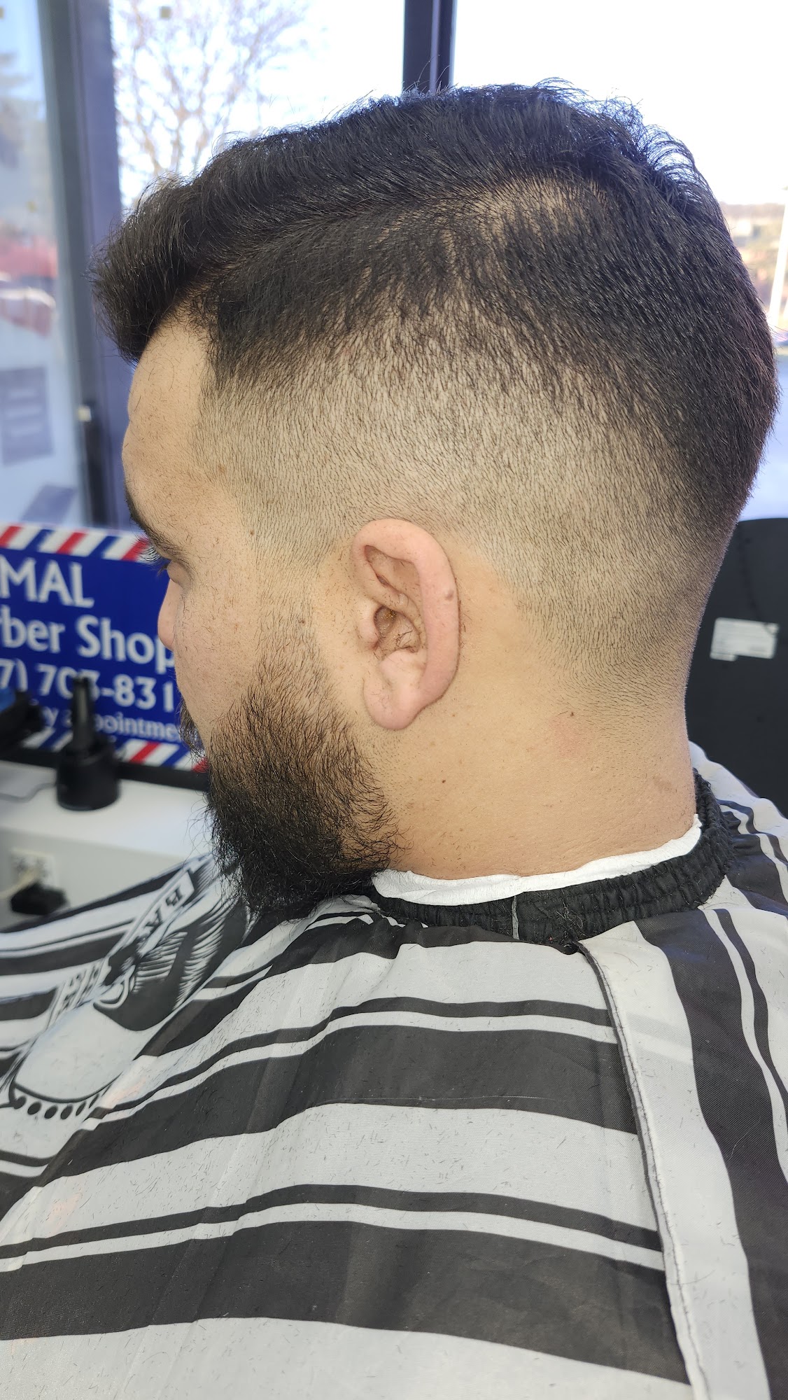 Fade haircut in progress at Kamal Barber Shop